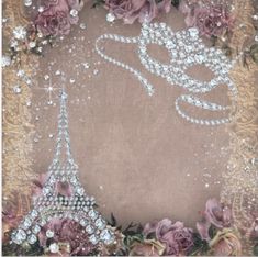 an image of the eiffel tower surrounded by flowers and pearls on a brown background