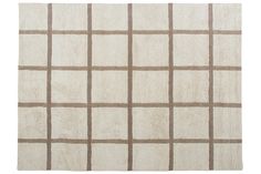 a white rug with brown squares on it