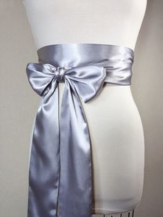 "Bright Silver Sash, Silver Satin Sash Silver Obi Wrap Belt Long Silver Sash Belt Wedding Accessories Silver Wedding Sash Satin Swank Make this Satin Swank® reversible waist sash the perfect finishing touch for your wedding, bridesmaid, or special occasion dress, or just the right piece to add instant polish to your dress or top. This extra long version is 3.5 inches wide, 120 inches long, and will wrap around most waist sizes two times with a generous length remaining to tie in a bow or a simpl Wedding Sash With Tie Back, Silver Fitted Sash For Party, Fitted Silver Sash For Party, Wedding Satin Tie Back Sash, Wedding Sashes With Satin Finish, Wedding Bridal Belt With Sashes In Satin, Satin Bridal Belt With Ribbon For Wedding, Elegant Wedding Sashes With Decorative Bow, Satin Wedding Sash