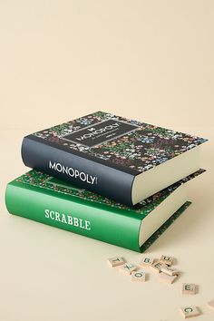 two books sitting on top of each other next to pieces of scrabble puzzle