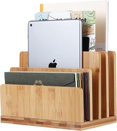 an ipad, tablet and folder holder made out of bamboo with different types of books