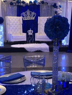 a blue and white wedding set up with chairs