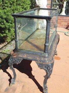 an old glass case sitting on top of a sidewalk