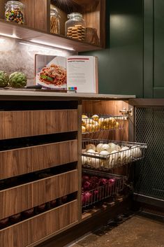 an open refrigerator filled with lots of food and veggies next to a counter