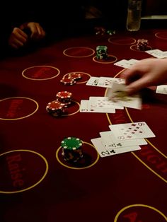 several people playing cards at a casino table