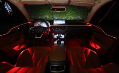 the interior of a car with red lights and electronic gadgets on it's dash boards