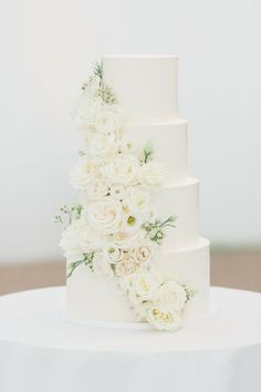 a wedding cake with white flowers on top