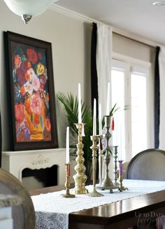 a dining room table with candles on it