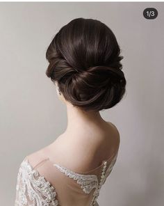 the back of a woman's head wearing a wedding dress