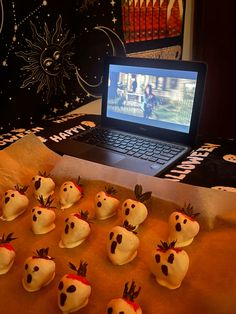 a laptop computer sitting on top of a table covered in fake food and marshmallows