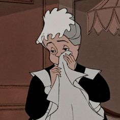 an older woman wiping her face with a napkin