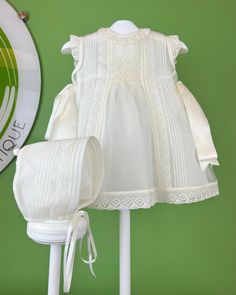 Smock Dress - Baptism Dress for Baby Girl - Made in Spain. Christening dress with smock detail. Off-white, lace, traditional, baptism dress. YoYo Boutique is located in Miami, and specializes on christening dresses, and baptism dresses. We ship worldwide. Sleeveless Dress With Smocked Back For Wedding, Classic Dresses With Broderie Anglaise For Daywear, Classic Broderie Anglaise Dresses For Daywear, Classic Broderie Anglaise Dresses For Daytime, Spring Ceremony Dresses With Ruffles, White Lace Dress With Broderie Anglaise, Elegant Beige Dresses With Smocked Back, Elegant Beige Dress With Smocked Back, White Ceremony Dress For Spring