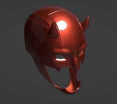 a red helmet with horns and fangs on it's face is seen in this image