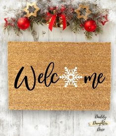 a welcome mat with christmas decorations on it