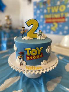 a toy story birthday cake with the number two on it's frosting and decorations