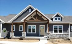 a gray house with white trim and windows