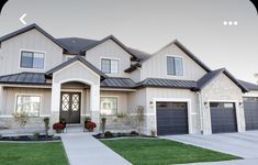 a large house with two garages on each side