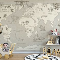 a child's room with a world map on the wall and toys in front