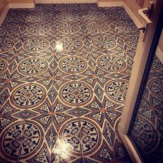 an ornate tiled floor in a bathroom