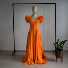 "Custom Made To Measure Orange Prom Dress, Short Sleeve Decorated With Genuine Ostrich Feathers Full Length Sequin Evening Party Dress, Maid of Honor Dress, Evening Dress. → Beautifully Flattering Luxurious Crepe Prom Dress In Any Colour. (Make Note Of The Colour) → Plus Sizing & Maternity Requirements To Accommodate More Personnel Perfect Dress → For More Conservative Style Sleeve/Dress Length Can be Changed To Your Preferred Length The 'Scarlet Maid' made with plenty of glamour in a gorgeo Orange Prom Dress Short, Dress With Ostrich Feathers, Sleeved Gown, Wedding Dress With Feathers, Orange Prom Dresses, Conservative Fashion, Velvet Bridesmaid Dresses, Maid Of Honour Dresses, Crepe Gown