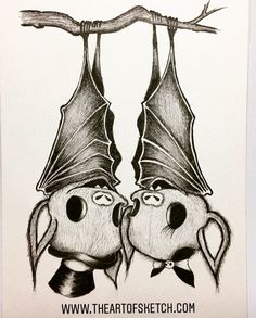 two bats hanging upside down on a branch with their heads turned to look like they are kissing