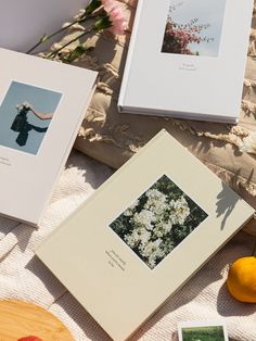 three framed photographs sitting on top of a table next to lemons and other items