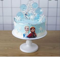 a frozen princess birthday cake with frosting and decorations on the top is ready to be eaten