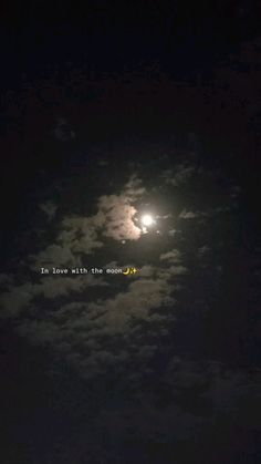 the moon and clouds are lit up in the night sky with words written on it