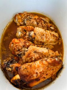 some chicken is cooking in a brown gravy