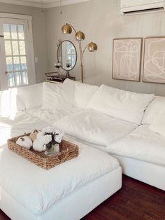 a large white sectional couch in a living room