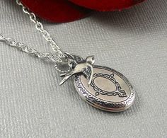 Oval shaped sweet and romantic necklace is 30 inches long. Burnish antique silver oval locket is engraved on both sides, with Victorian style different patterns/motifs. I have accented the locket with sterling silver plated swallow sparrow charm. Necklace is hanging from silver chain and silver lobster clasp. Locket is 21x16mm in size. It opens sideway and has room for two photos! Thanks for looking:) ~Mani Antique Silver Oval Locket Necklace For Gift, Antique Silver Oval Locket Necklace, Silver Oval Locket Necklace Nickel Free, Silver Oval Locket Necklace Nickel-free, Silver Oval Locket Necklace For Vintage Collection, Oval Silver Locket Necklace For Vintage Collection, Antique Silver Sterling Silver Oval Locket Necklace, Oval Antique Silver Sterling Locket Necklace, Oval Locket Necklace In Antique Silver Sterling Silver