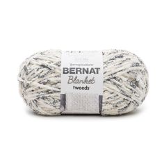 bernat blanket tweeds yarn in white and grey with black stripes on the bottom