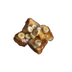 two pieces of bread with bananas on top and powdered sugar on the bottom, against a white background