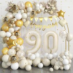 balloons and confetti are arranged in the shape of a 90th birthday sign