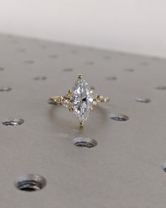 a diamond ring sitting on top of a metal surface