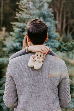 a man and woman standing in front of a christmas tree