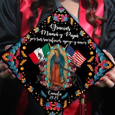 a woman wearing a graduation cap with an image of the virgin mary papaga on it