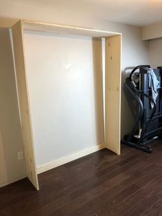 an empty room with a treadmill and exercise equipment