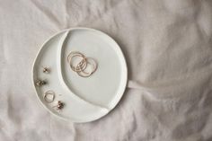 two white plates with gold rings on them