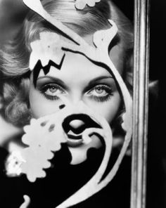 a black and white photo of a woman with clown makeup