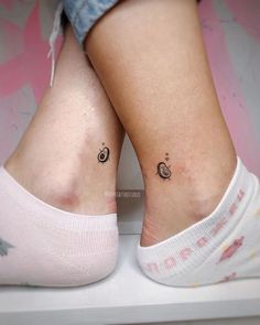 two people with small tattoos on their legs