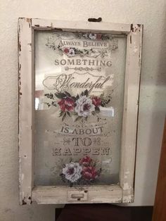 an old window frame with flowers on it and the words something beautiful is about to happen