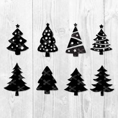 christmas trees cut out from black paper on white wood