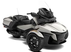 a white and black can - am spyster parked on top of a white surface