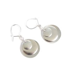 "These handmade eclipse drop earrings feature a trio of bright sterling silver discs that provide visual interest from the front and the back. They dangle from kidney earring wires that latch closed and are approximately 3/4\" wide and 1 1/2\" long, including the earring wire.  * In stock. Ships for free (US orders only) within 1-2 business days." Carter Jewelry, Earring Wire, The Eclipse, Earring Wires, Sterling Silver Drop Earrings, Silver Drop Earrings, Sterling Silver Earrings, Jewelry Earrings Dangle, Silver Earrings