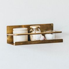 a shelf with some jars and containers on it