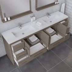 a bathroom vanity with two sinks and mirrors