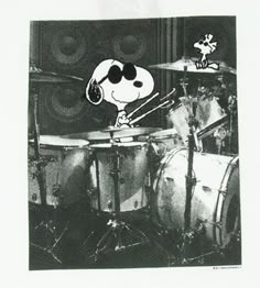 the peanuts character is playing drums on stage