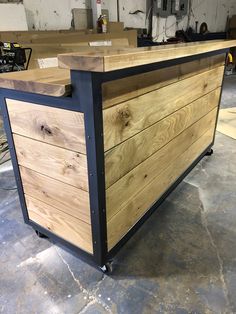 a large wooden box sitting on top of a hard wood floor in a warehouse or workshop