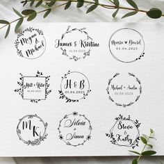 wedding stickers on top of a piece of paper with greenery around the edges